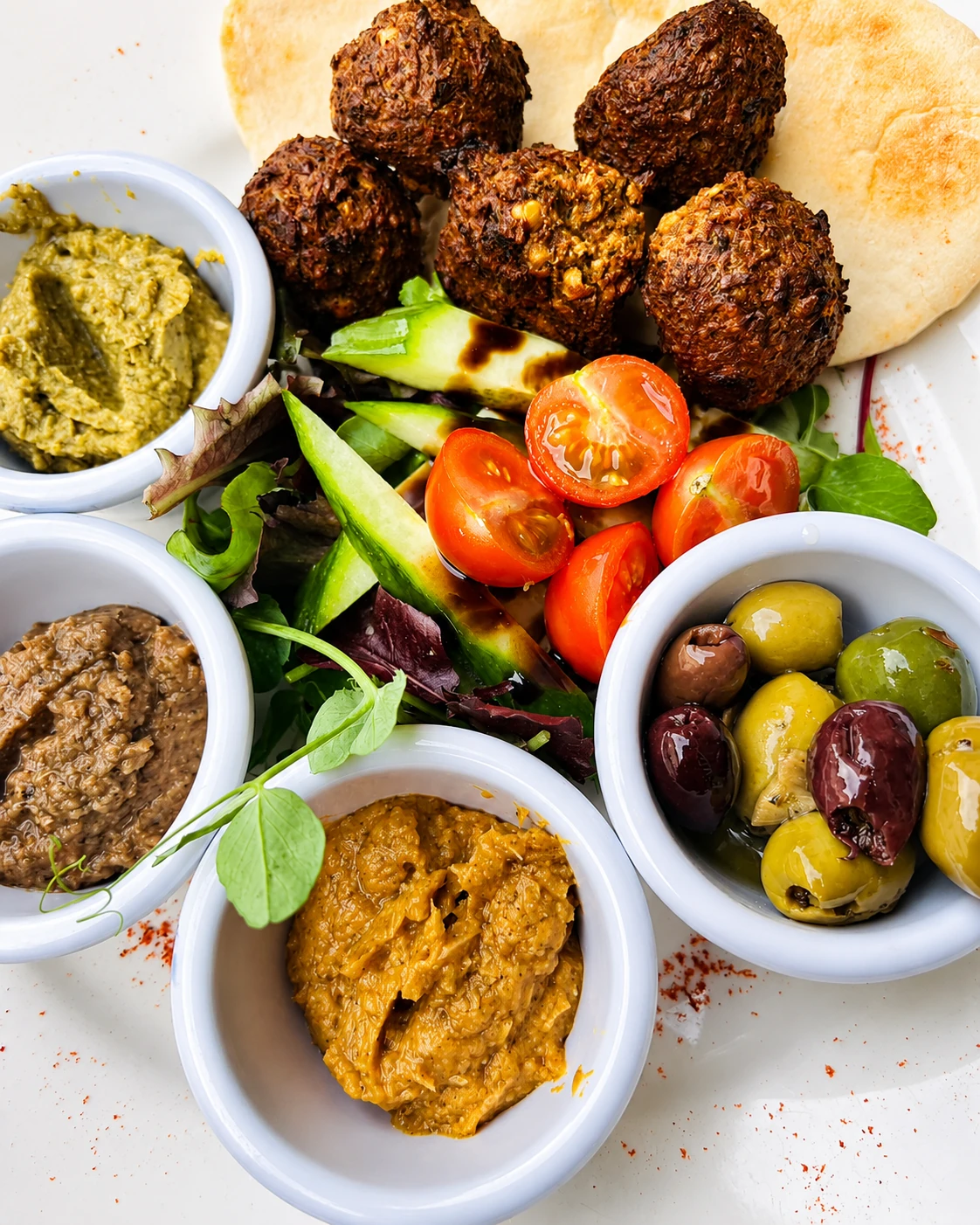 Falafel platter with dips, salad and olives